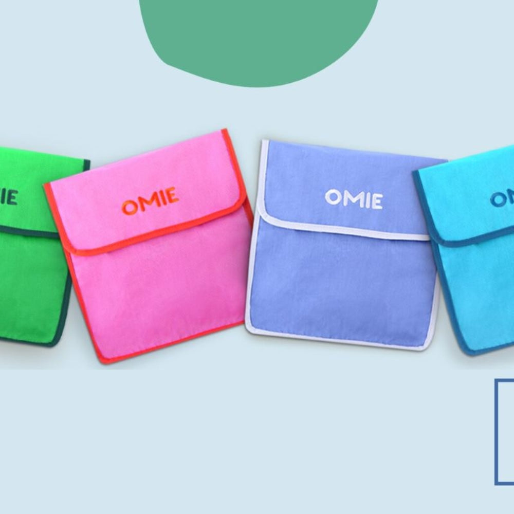 Fioletowa torba lunchowa dla dzieci OmieTote – wodoodporna, składana, z kieszeniami i paskiem na ramię.